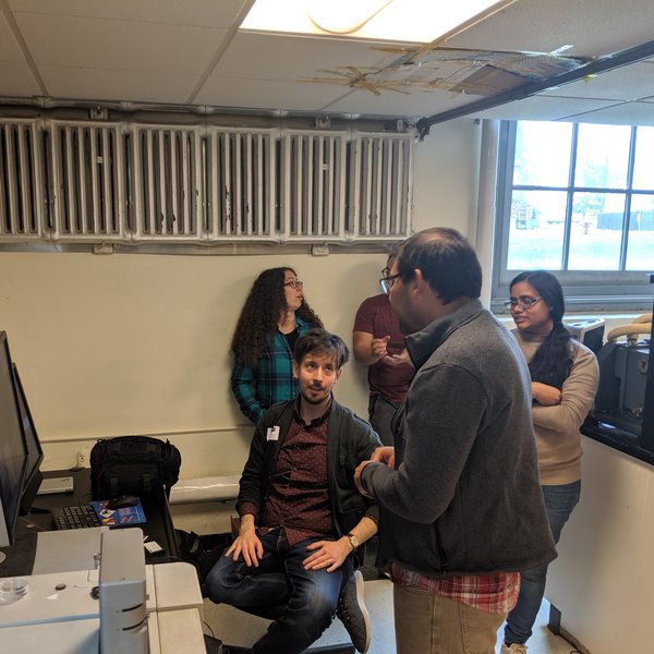 NITE Lab members in discussion with an Asylum Research representative during a site visit.